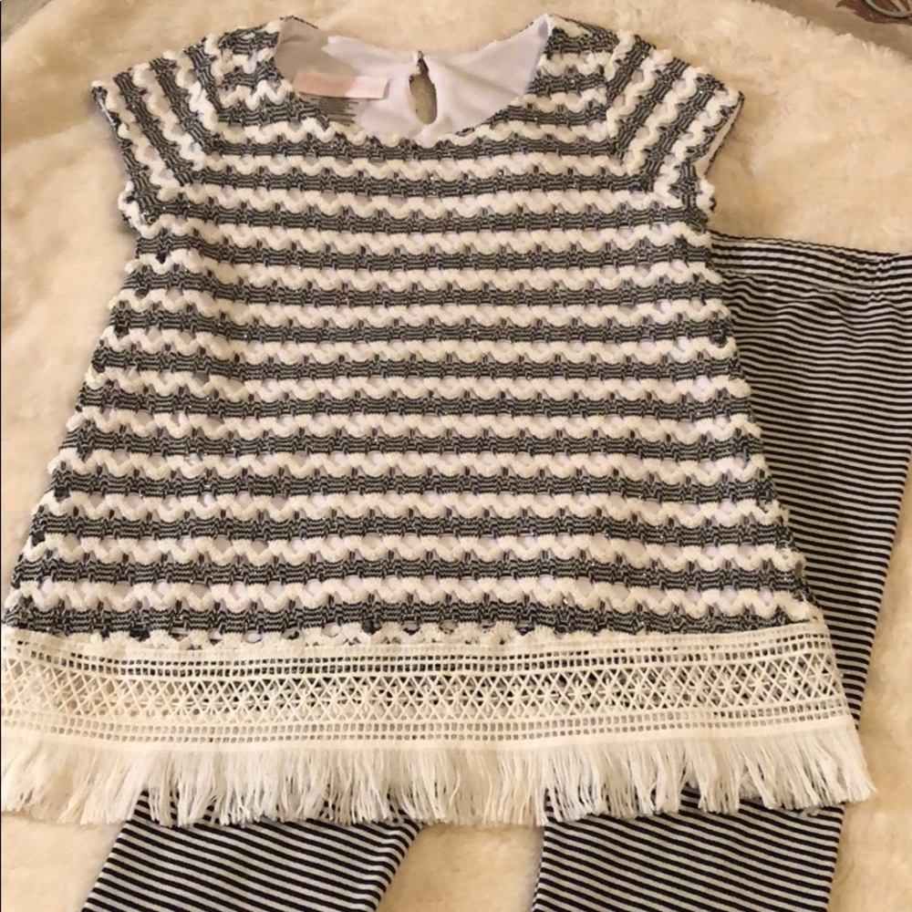 Matching black and white outfit with detailed hem.